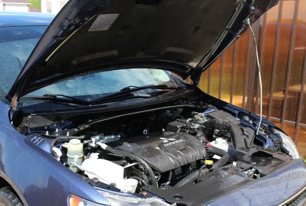 a car with open hood showing the engine